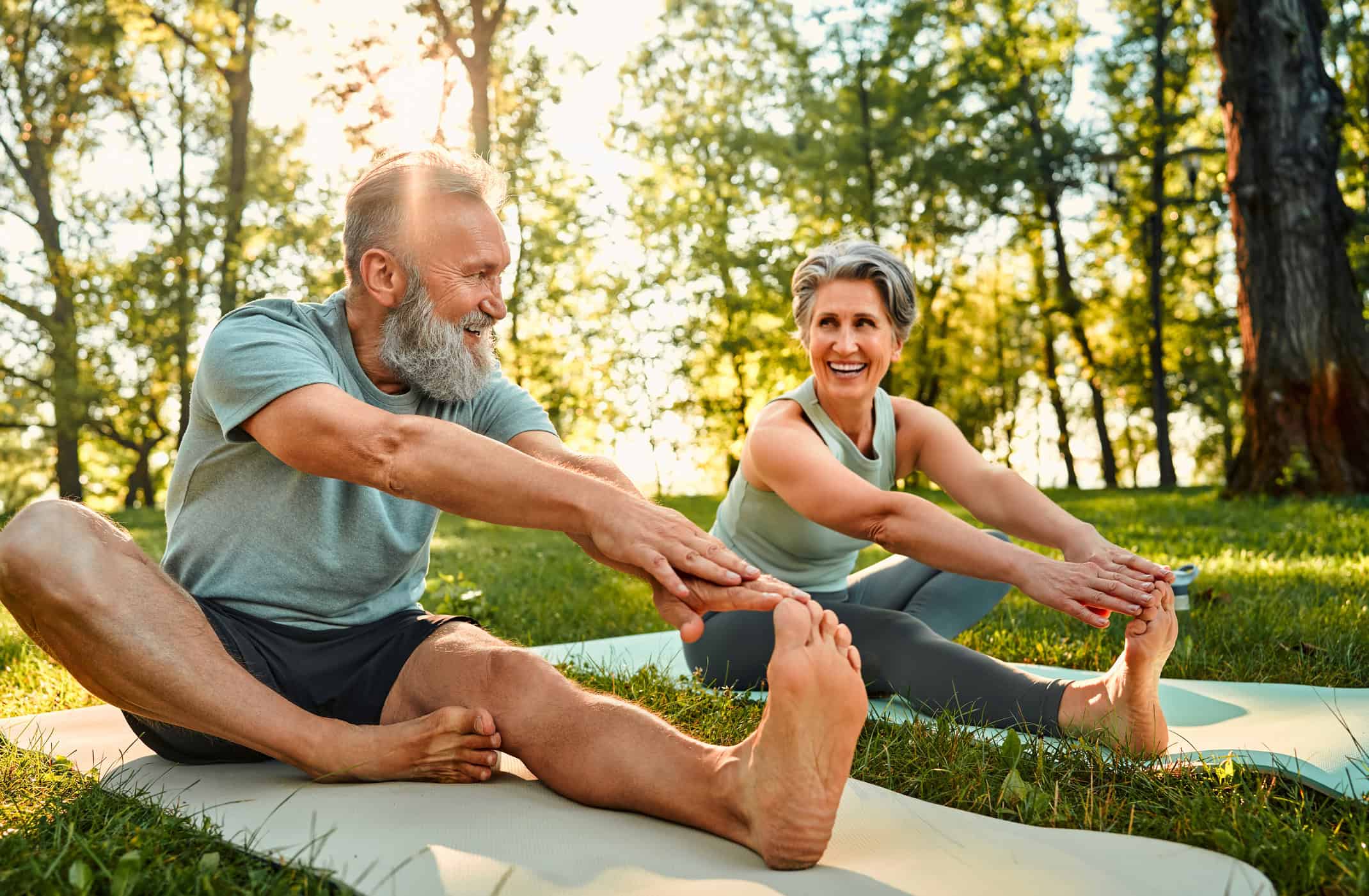 man and woman stretching in a park